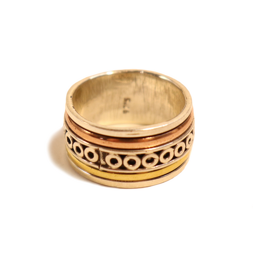 silver and brass spinning meditation ring.  3 rings swirl around a larger ring